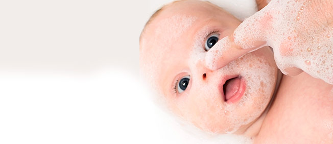 Closeup of beautiful baby covered in soap